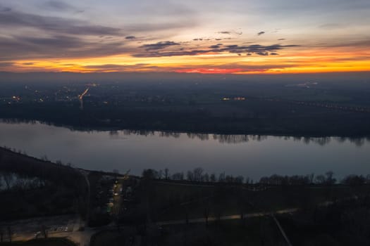 Cremona, Italy - January 2023 Sunset in plain near the city, Po bridge connecting Emilia Romagna and Lombardy