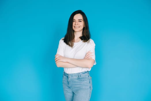 Confident and Successful Female Office Manager - Charming Businesswoman in Casual Attire with Arms Crossed - Isolated on Blue Background - Ideal for Career and Business Concepts.