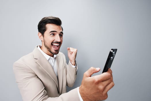 smartphone man smile beige suit phone cyberspace background portrait mobile happy online adult phone hold mobile business technology businessman person call lifestyle