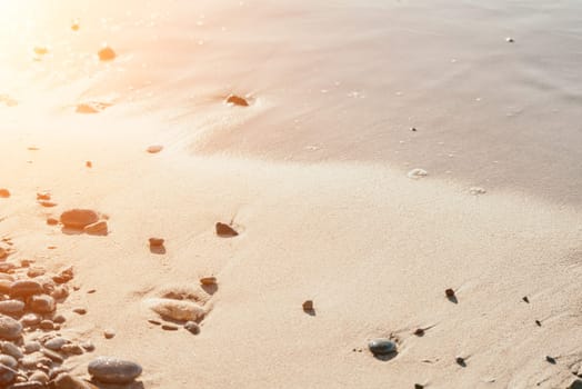 Abstract sea summer ocean sunset nature background. Sound of small waves on golden water surface in motion blur with golden bokeh lights from sun. Holiday, vacation and recreational concept.