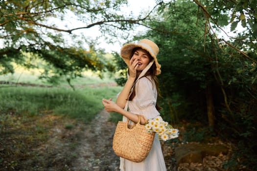 happy, smiling woman in a wicker hat with a basket of daisies in her hands walks through the forest. High quality photo