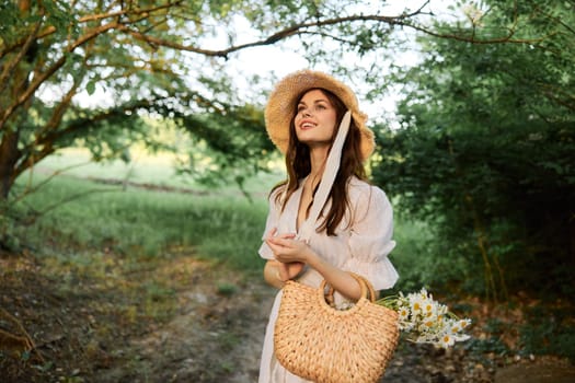happy, smiling woman in a wicker hat with a basket of daisies in her hands walks through the forest. High quality photo