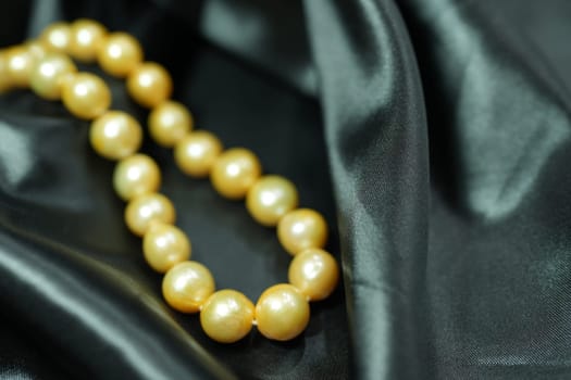 Golden South sea Pearl necklace on black satin background