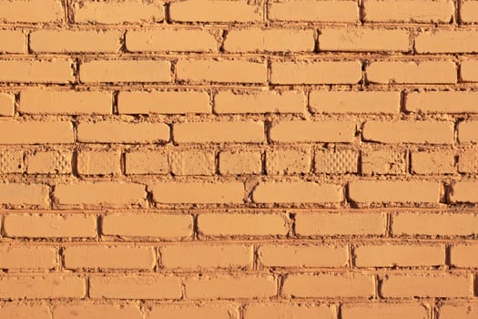 Wall and yellow brick background is the texture of a wall made of bright yellow brick, a wall painted yellow