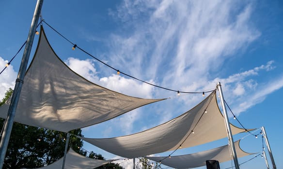 Canvas shade canopies against a blue sky