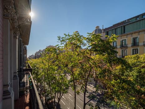 View from balcony of street of Barcelona in Eixample district on sunny summer day in Spain.