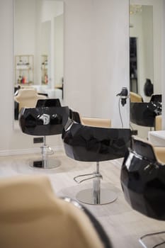 Interior of beauty salon with chairs and mirrors. Furniture in modern hairdressing.