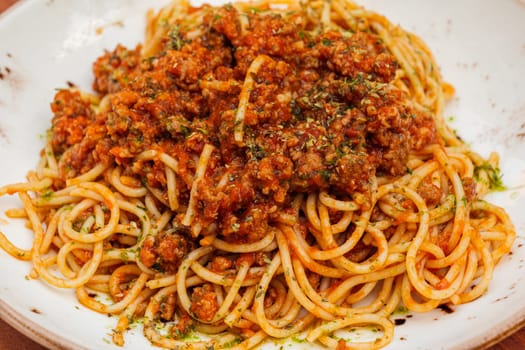 Spaghetti bolognese - Italian traditional dish. Mediterranean cuisine with pasta ingredients - bolognese sauce, olive oil and tomato