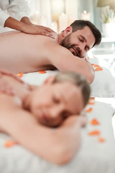 Couple, relax and luxury spa massage enjoying peaceful relaxation or pamper session together at holiday resort. Man and woman in relationship relaxing in calming health and zen treatment on vacation.