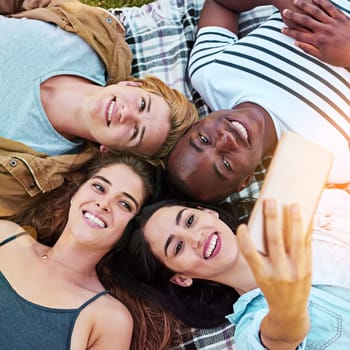 Friends, top view and outdoor for circle selfie, happiness and diversity for social media post, app or blog. Men, woman and youth for photography, profile picture and bonding while lying on ground.