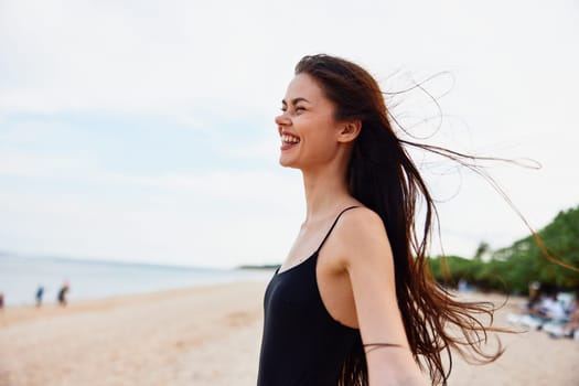 woman ocean young smile peaceful sunlight travel smiling bag sand happiness beach free shore vacation person walk summer nature sea female