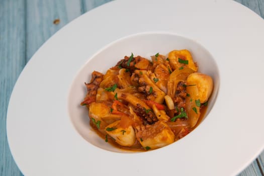 Recipe for octopus Provencal style, tomato, onion, garlic, red pepper, parsley, High quality photo