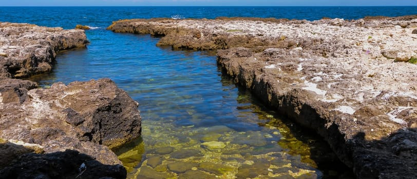 Karst cavity failure in the rocky shore, flooded by water in the eastern Crimea, Black Sea