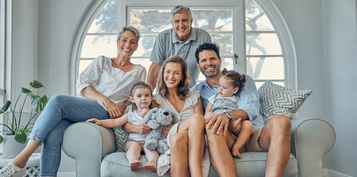 Happy family, portrait and relax on a sofa with happy, smile and cheerful people in their home together. Love, family and kids with parents and grandparents in a living room, bond and laugh on couch.