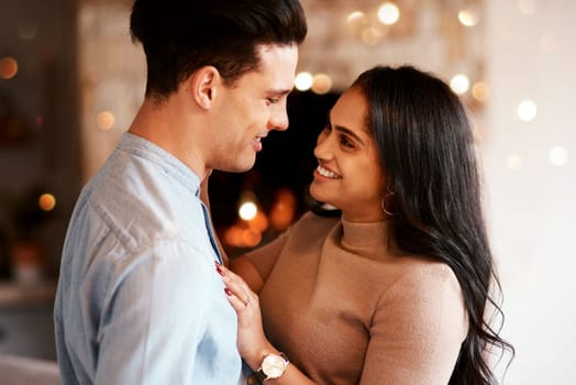 Love, romance and happy couple hugging on a date for valentines day, romantic event or anniversary. Happiness, smile and interracial man and woman embracing after a dinner celebration together