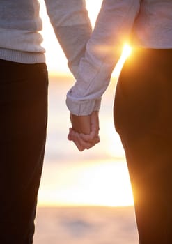 Back of couple holding hands at beach, sunset and vacation of save the date marriage. Closeup hand of man, woman and walking in sunshine, relax and trust of support, peace and love, travel or freedom.