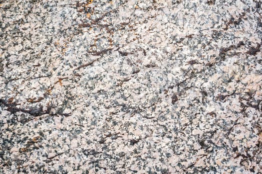 The texture of a stone from chipped granite, a close-up of the surface of the rock.