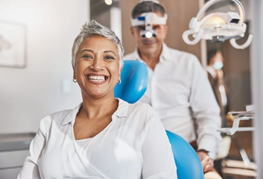 Portrait, happy and dental with a woman patient in a doctor office for oral hygiene or health. Smile, teeth and healthcare with a senior female sitting in a chair at the dentist for hygiene.