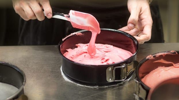 chef preparing white pink red cake creamy mixtures doughs to bake in the oven