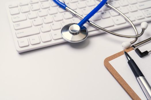 Medical Concept - Stethoscope on computer keyboard on white background. Physician long term care treatment. Close up, macro, copy space