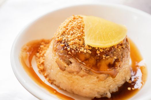 Rice pudding (Tube rice cake), popular delicious taiwanese street food gourmet delicacy, made by glutinous rice and pork with sweet chili sauce.