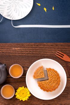 Creative Moon cake Mooncake design inspiration, enjoy the moon in Mid-Autumn festival with pastry and tea on wooden table concept, top view, flat lay