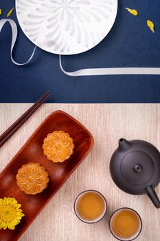 Creative Moon cake Mooncake design inspiration, enjoy the moon in Mid-Autumn festival with pastry and tea on wooden table concept, top view, flat lay