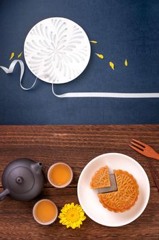 Creative Moon cake Mooncake design inspiration, enjoy the moon in Mid-Autumn festival with pastry and tea on wooden table concept, top view, flat lay