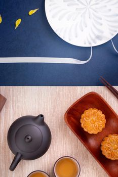Creative Moon cake Mooncake design inspiration, enjoy the moon in Mid-Autumn festival with pastry and tea on wooden table concept, top view, flat lay