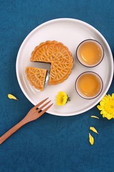 Minimal simplicity layout moon cakes on blue background for Mid-Autumn Festival, creative food design concept, top view, flat lay, copy space.
