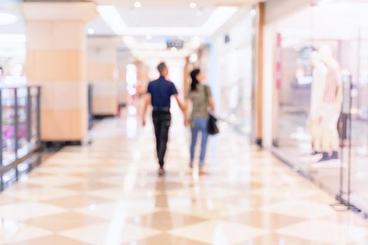 Luxury department store shopping mall interior, abstract defocused blur with bokeh background, concept of shopping seasons design.