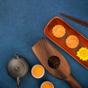 Minimal simplicity layout moon cakes on blue background for Mid-Autumn Festival, creative food design concept, top view, flat lay, copy space.