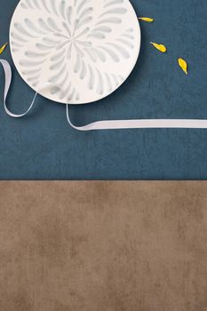 Conceptual Mid-Autumn Festival table background, symbol of moon, clouds and stars in the sky with plate, ribbon and yellow petal. Top view, flat lay.