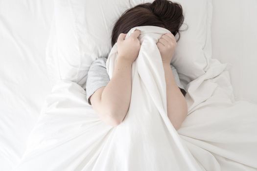 Portrait of young beautiful woman in bed