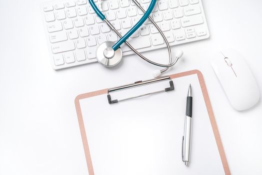 Doctor diagnoses concept - stethoscope on computer keyboard with medical record case and pen on white working table. Top view, flat lay, copy space