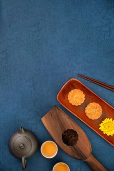 Minimal simplicity layout moon cakes on blue background for Mid-Autumn Festival, creative food design concept, top view, flat lay, copy space.
