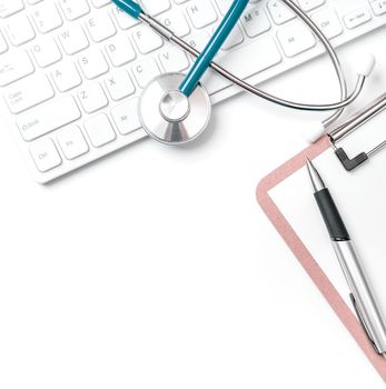 Doctor diagnoses concept - stethoscope on computer keyboard with medical record case and pen on white working table. Top view, flat lay, copy space