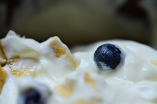 Close-up of blueberries and pieces of banana in yoghurt