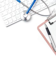Medical Concept - Stethoscope on computer keyboard on white background. Physician long term care treatment concept. Top view, flat lay, copy space