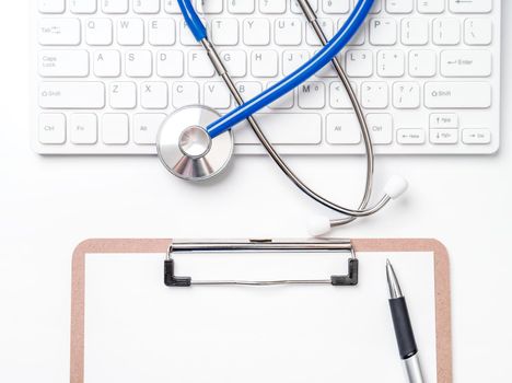 Medical Concept - Stethoscope on computer keyboard on white background. Physician long term care treatment concept. Top view, flat lay, copy space