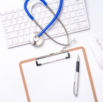 Medical Concept - Stethoscope on computer keyboard on white background. Physician long term care treatment concept. Top view, flat lay, copy space