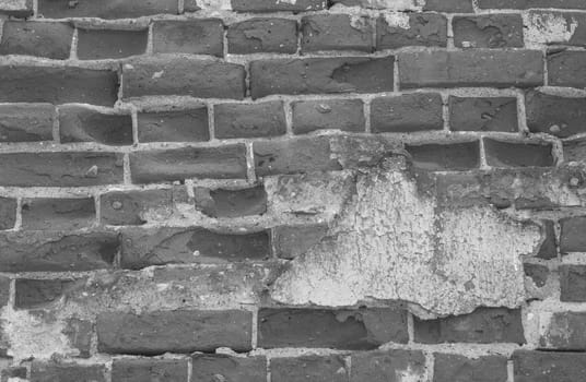 The surface is made of old deformed and brick with stripped plaster. The wall is made of old ancient brick.