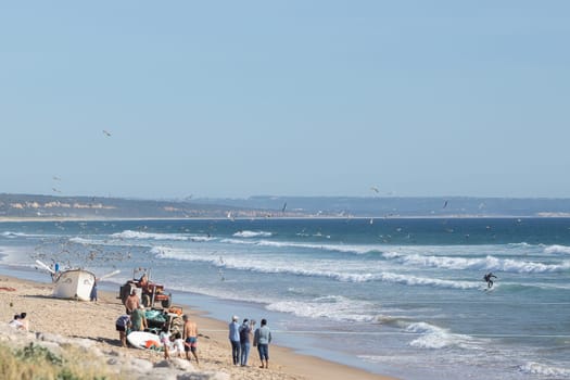 24 April 2023 Lisbon, Portugal: fishermen on the seashore. Mid shot