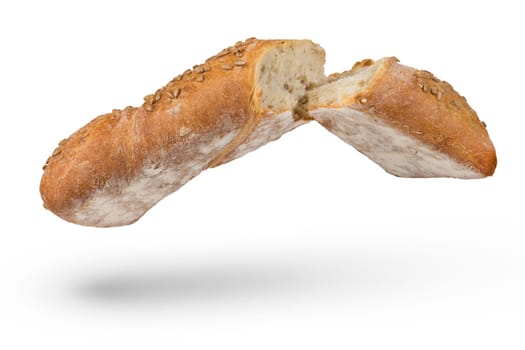 Fresh loaf of light bread on a white isolated background. Healthy food concept. A loaf broken in half, isolated on a white background, casts a shadow. Side view.