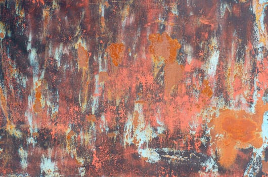 Texture of an old rusty metal sheet with red and gray paint elements. close-up.