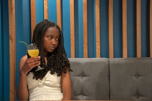 copy space of afro girl with depression with a cocktail in her hand. High quality photo