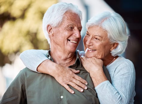 Love, romance and dating with a senior couple hugging outdoor in nature together during retirement. Relax, park and countryside with a mature man and woman bonding in a garden during summer.