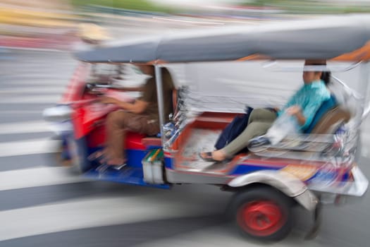 Traditional tuk-tuk from Bangkok, Thailand, in motion blur