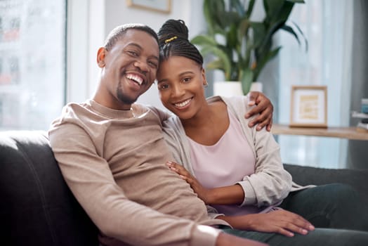 Black couple, hug and portrait smile on sofa in relax for relationship bonding together at home. African American man and woman smiling in joyful happiness for quality free time on living room couch.