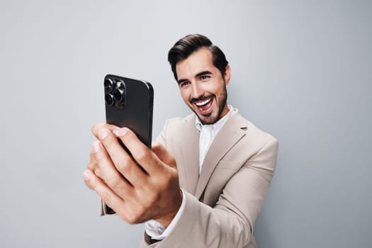 man hold smile suit isolated smartphone happy message cyberspace communication adult confident portrait lifestyle trading business mobile call studio phone phone male